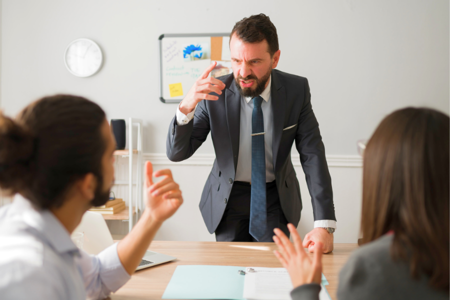 man shouting at another man pointing his finger
