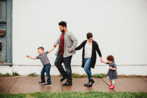 family walking in a line, holding hands