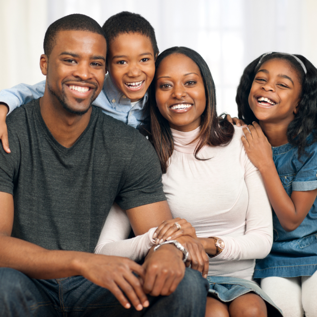 family posing for a photo in a room