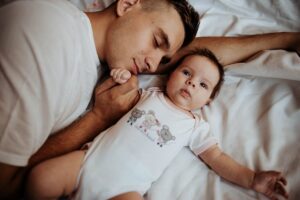 douglass runger Father Lying on the Bed with His Little Baby paternity suits