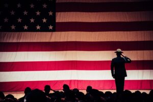 douglass runger Man Standing On Stage Facing An American Flag