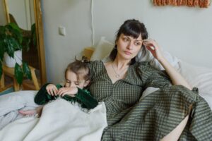 douglass runger Tired-mother-with-cute-daughter-resting-child-support-modification