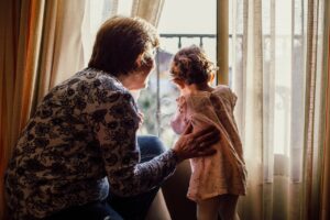douglass runger woman holding baby near window guardianships