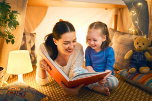 mother with child on the floor reading a book