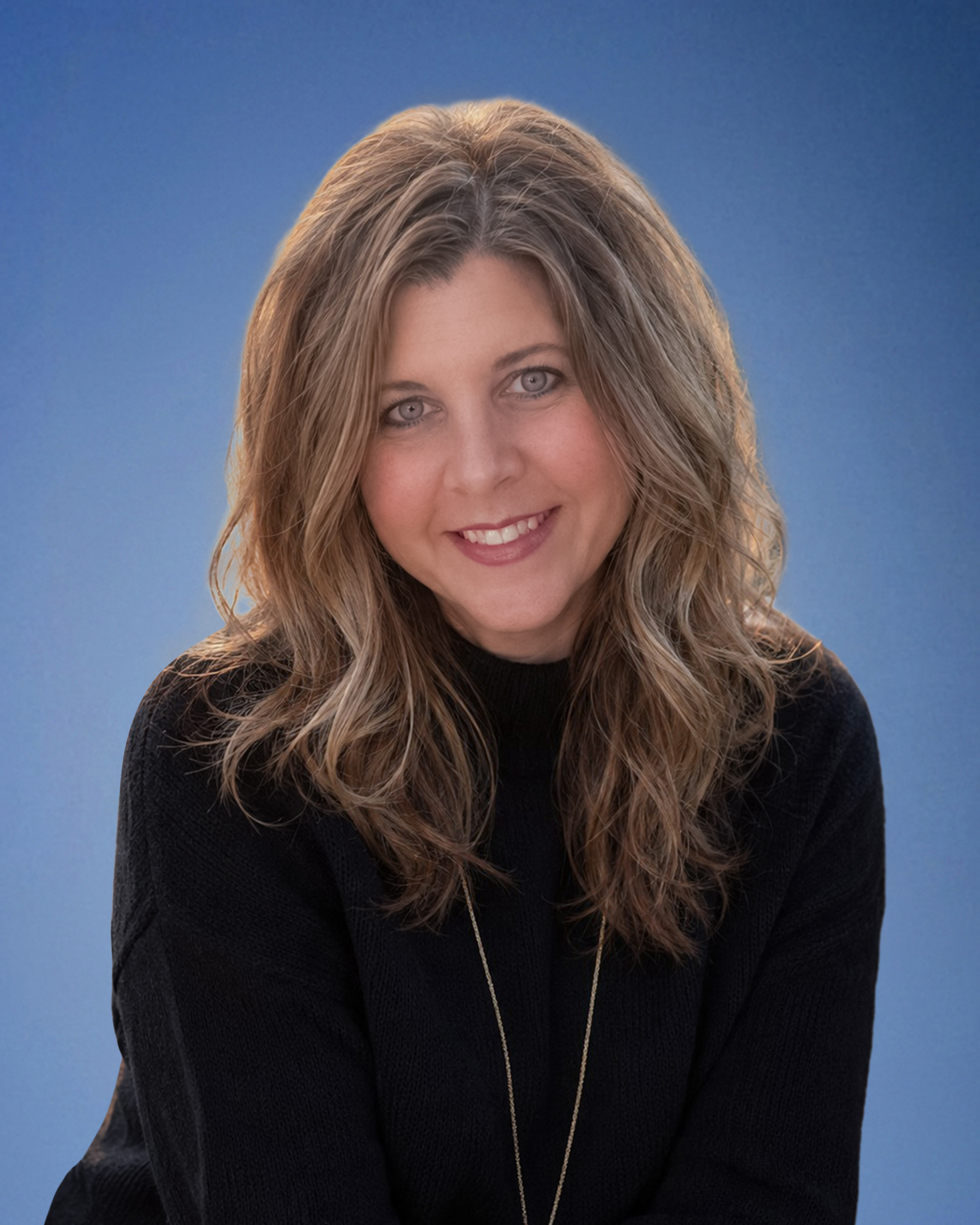 Smiling woman with long wavy blonde hair wearing a black sweater against a blue gradient backdrop, facing the camera.